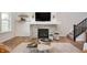 Cozy living room showcasing a modern fireplace with stone accents, floating shelves, and stylish decor, creating a warm ambiance at 8452 Ironhill Ct, Indianapolis, IN 46259