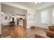 Open-concept living space featuring wood-look floors, a kitchen, dining area, sitting room, and ample natural light at 8452 Ironhill Ct, Indianapolis, IN 46259