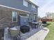 Outdoor patio with a dining table, chairs, a wicker sofa, a grill, a fire pit, and a brick exterior at 8926 New Heritage Ct, Indianapolis, IN 46239
