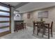 Basement featuring a custom wet bar, bar seating and adjacent dining set at 8926 New Heritage Ct, Indianapolis, IN 46239
