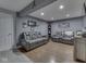 Finished basement features gray walls, wood floor, comfy leather furniture, and a display cabinet with sports memorabilia at 8926 New Heritage Ct, Indianapolis, IN 46239