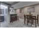 Basement featuring a custom wet bar with seating, and adjacent bathroom at 8926 New Heritage Ct, Indianapolis, IN 46239