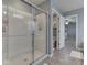 Modern bathroom with glass-enclosed shower, tiled floor, and adjacent toilet room for added privacy at 8926 New Heritage Ct, Indianapolis, IN 46239