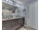 Bathroom featuring dual sinks with modern fixtures, ample counter space, and a clean, contemporary design at 8926 New Heritage Ct, Indianapolis, IN 46239