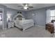 Spacious bedroom features a ceiling fan and a comfortable chair, bathed in soft, natural light at 8926 New Heritage Ct, Indianapolis, IN 46239