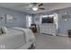 Serene bedroom features a dresser with TV and a comfortable chair, illuminated by natural light at 8926 New Heritage Ct, Indianapolis, IN 46239