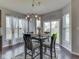 Cozy dining area features wood floors, a modern light fixture and large windows that provide ample natural light at 8926 New Heritage Ct, Indianapolis, IN 46239