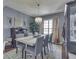 Dining room with rustic wood table, chandelier, gray walls, dark hard wood floors, and modern decor at 8926 New Heritage Ct, Indianapolis, IN 46239