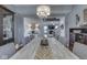 Dining area features a large table, modern chandelier, and open access to living area at 8926 New Heritage Ct, Indianapolis, IN 46239