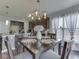 Comfortable dining area with modern chandelier and a view of the kitchen, perfect for meals at 8926 New Heritage Ct, Indianapolis, IN 46239