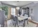 Dining room showcasing elegant chandelier, large table, and stylish decor with large windows at 8926 New Heritage Ct, Indianapolis, IN 46239