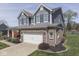 Attractive two-story home featuring blue siding, brick details, and attached two car garage at 8926 New Heritage Ct, Indianapolis, IN 46239