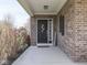 Inviting front porch with brick accents, black door, and a welcoming entrance at 8926 New Heritage Ct, Indianapolis, IN 46239