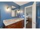 Stylish bathroom with granite counters, modern fixtures, and blue accent wall at 1016 Silver Lake Ct, Greenwood, IN 46142