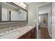 Modern bathroom with double sinks, granite countertops, and a large framed mirror at 1016 Silver Lake Ct, Greenwood, IN 46142