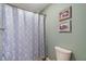Full bathroom featuring a patterned shower curtain, a toilet, and two framed pictures at 1016 Silver Lake Ct, Greenwood, IN 46142