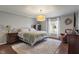 Cozy bedroom with a queen bed, plush rug, and ample natural light at 1016 Silver Lake Ct, Greenwood, IN 46142