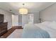 Cozy bedroom features wood floors, a soft rug, and a view into an en suite bathroom at 1016 Silver Lake Ct, Greenwood, IN 46142