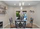 Dining area with glass table, modern lighting, and patio doors to the pool at 1016 Silver Lake Ct, Greenwood, IN 46142