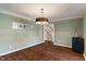 Dining room featuring wood floors, crown molding, and open access to the staircase at 1016 Silver Lake Ct, Greenwood, IN 46142