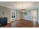 Bright dining room with wood floors, modern light fixture, and large windows at 1016 Silver Lake Ct, Greenwood, IN 46142