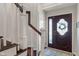 Inviting entryway with staircase and dark wooden door with glass inserts at 1016 Silver Lake Ct, Greenwood, IN 46142
