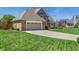 Lovely home showcasing a well-maintained lawn, brick exterior, and attached two-car garage at 1016 Silver Lake Ct, Greenwood, IN 46142