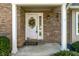 Close-up of a white front door with decorative wreath and brick facade at 1016 Silver Lake Ct, Greenwood, IN 46142