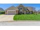 Charming two-story brick home with a manicured lawn and attached two-car garage at 1016 Silver Lake Ct, Greenwood, IN 46142
