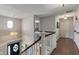 Bright hallway featuring hardwood floors, modern lighting, and staircase to the lower level at 1016 Silver Lake Ct, Greenwood, IN 46142