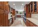 Spacious kitchen with cherry cabinets, quartz countertops, and stainless steel appliances at 1016 Silver Lake Ct, Greenwood, IN 46142