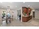 Open concept kitchen featuring tile floors, wooden cabinetry, and views of the backyard pool at 1016 Silver Lake Ct, Greenwood, IN 46142