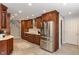 Well-equipped kitchen featuring cherry cabinetry, stainless steel refrigerator, and ample counter space at 1016 Silver Lake Ct, Greenwood, IN 46142