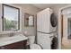 Laundry room featuring stacked washer and dryer, sink and a window at 1016 Silver Lake Ct, Greenwood, IN 46142
