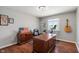 Home office features a large desk, exercise bike, and natural light at 1016 Silver Lake Ct, Greenwood, IN 46142