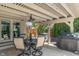 Covered patio with outdoor seating, grill, and string lights, perfect for entertaining at 1016 Silver Lake Ct, Greenwood, IN 46142