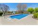Backyard pool with basketball hoop, chairs and beautiful landscaping, overlooking a lake at 1016 Silver Lake Ct, Greenwood, IN 46142