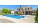 Beautiful backyard features a pool, basketball hoop, and patio with seating at 1016 Silver Lake Ct, Greenwood, IN 46142