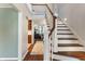 Bright foyer with a wooden staircase and view into the living room at 1016 Silver Lake Ct, Greenwood, IN 46142
