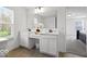 Bathroom with double vanity, white cabinets, and a large mirror at 10524 Broadford St, Indianapolis, IN 46239