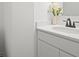 A modern bathroom featuring a white vanity, countertop, sink, faucet, and a decorative flower vase at 10524 Broadford St, Indianapolis, IN 46239