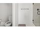 Modern white bathroom with a toilet, towel bar, and a glass-enclosed shower with tile surround at 10524 Broadford St, Indianapolis, IN 46239