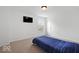 Bright bedroom featuring neutral carpet, a television, and a cozy, blue-striped bedspread at 10524 Broadford St, Indianapolis, IN 46239