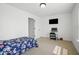Bedroom with neutral carpet, a television, desk, and a cozy, blue-floral bedspread at 10524 Broadford St, Indianapolis, IN 46239