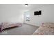 Inviting bedroom with twin beds, a window, and a mounted TV, offering comfort and style at 10524 Broadford St, Indianapolis, IN 46239