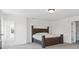 Bedroom with a large wood bed frame, carpet, and an ensuite bathroom at 10524 Broadford St, Indianapolis, IN 46239