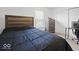 Cozy bedroom featuring a comfy bed, matching dresser, and sliding door closet under natural light at 10524 Broadford St, Indianapolis, IN 46239