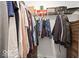 Organized walk-in closet featuring a variety of hanging clothes and wire shelving for optimal storage solutions at 10524 Broadford St, Indianapolis, IN 46239