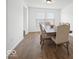 Bright dining room featuring a wooden table and chairs beneath a modern light fixture and large windows at 10524 Broadford St, Indianapolis, IN 46239