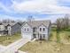 Two-story home with gray siding, a two-car garage, concrete driveway, and manicured lawn at 10524 Broadford St, Indianapolis, IN 46239